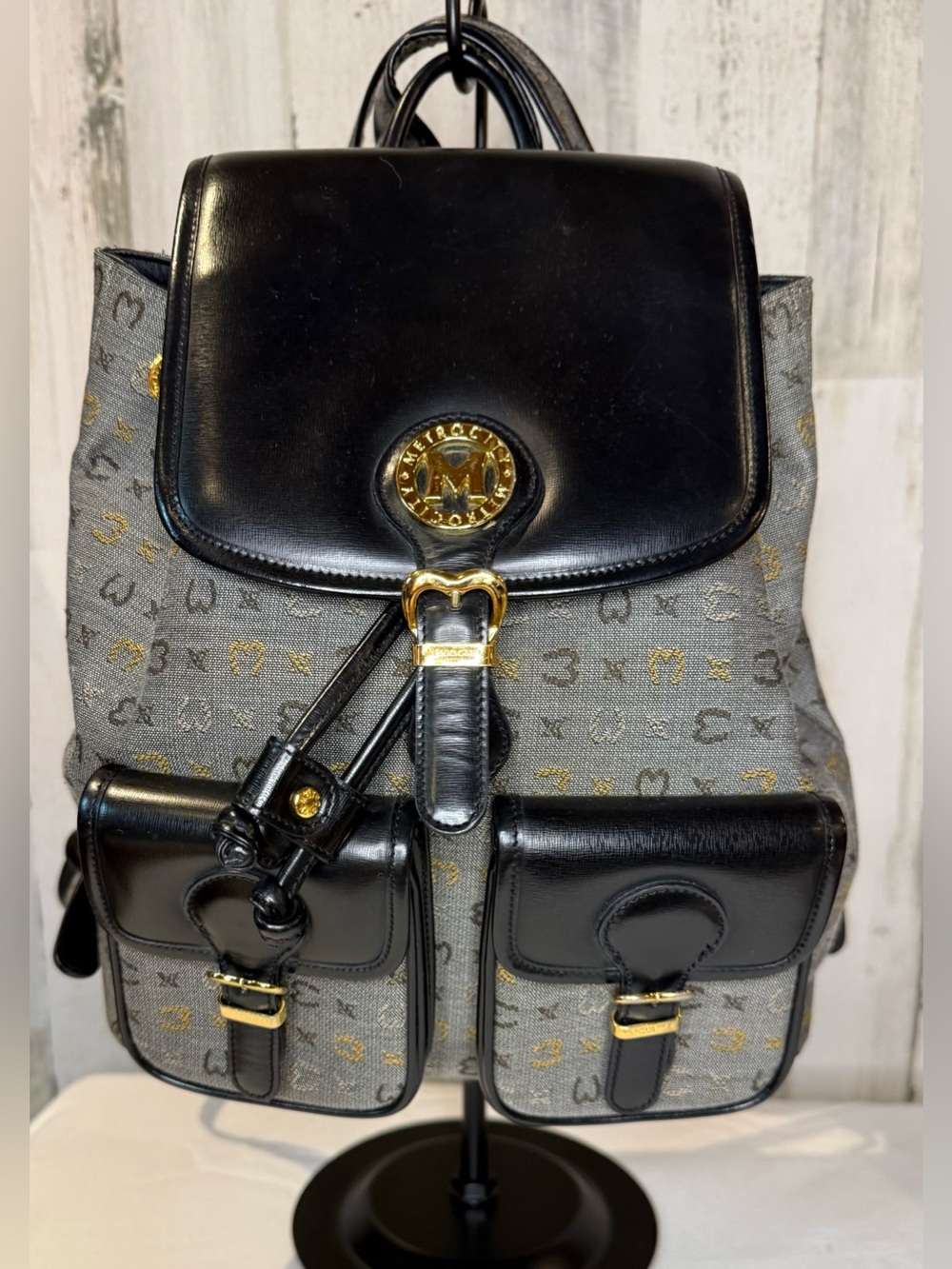 Metrocity Signature Canvas Backpack with black leather trim and gold hardware